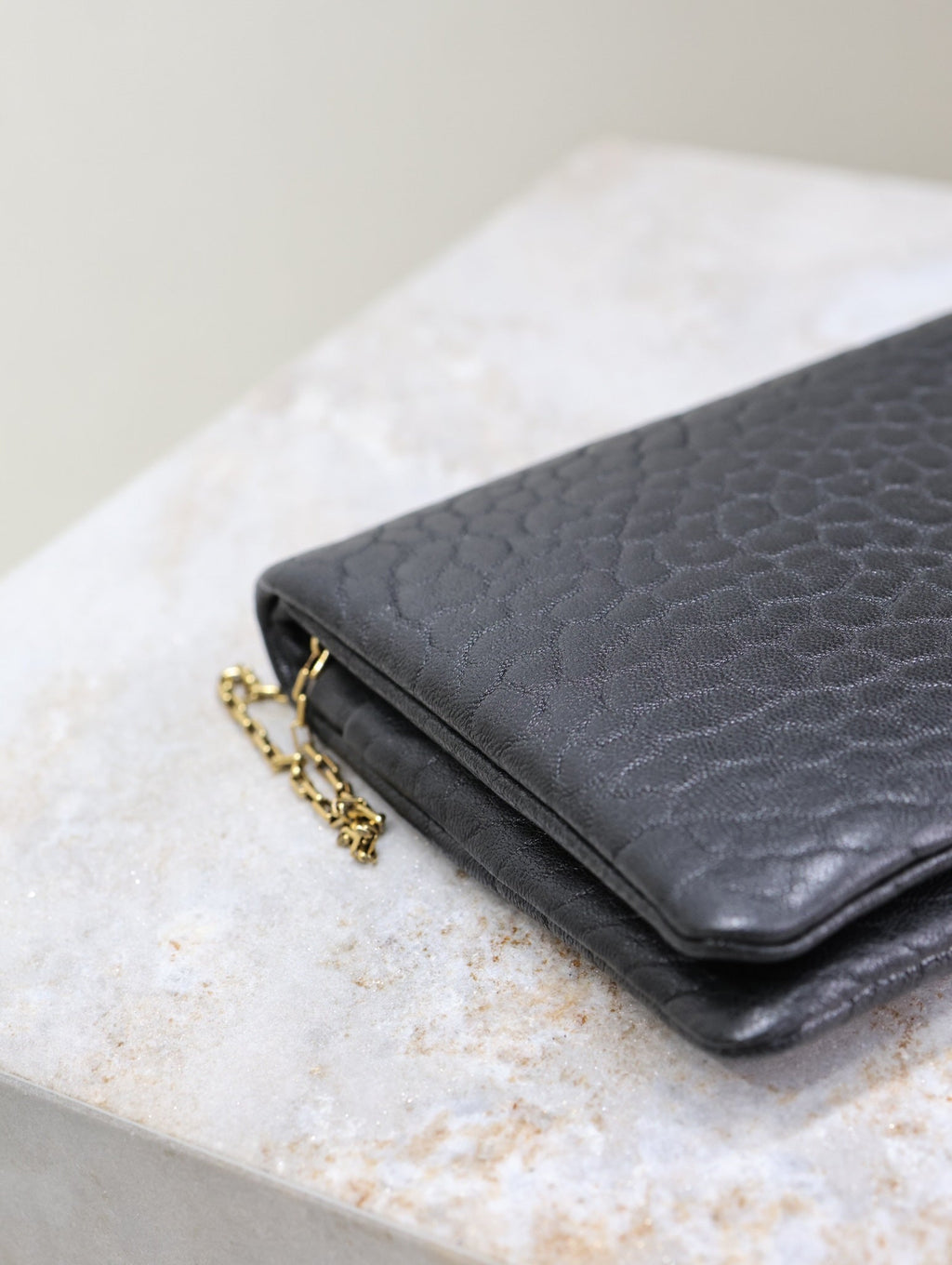 CALYPSO POUCH 24 IN BLACK ELEPHANT TEXTURED LAMBSKIN GOLD LOGO
